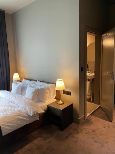 a bedroom with a bed and a lamp on a table at REZYDENCJA BOHEMA in Szczawno-Zdrój