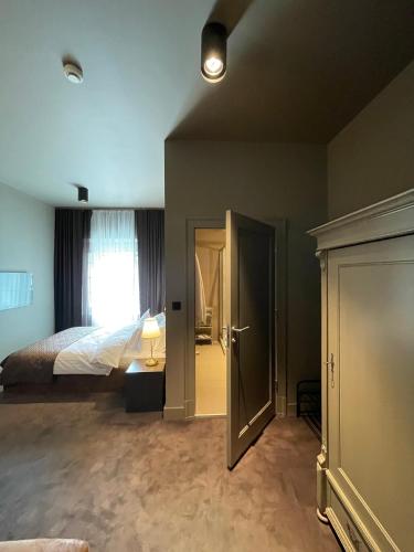 an empty bedroom with a bed and a window at REZYDENCJA BOHEMA in Szczawno-Zdrój