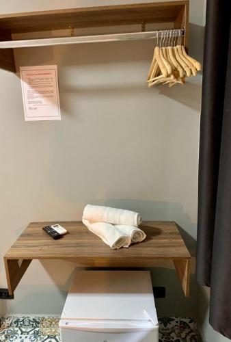 a wooden table with a towel on top of a toilet at Santa Cecília Pousada in Guarujá