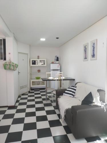 ein Wohnzimmer mit einem schwarz-weiß karierten Boden in der Unterkunft Apto Completo, privativo, garagem portao automatico in Juazeiro