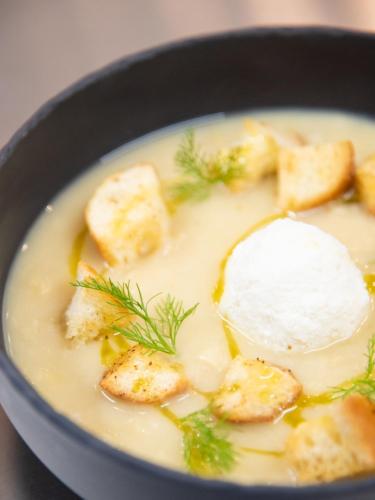 a bowl of soup with bread and sour cream at Modica Boutique Hotel in Modica