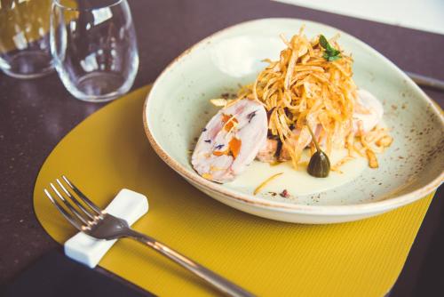 a bowl of food on a table with a fork at Modica Boutique Hotel in Modica