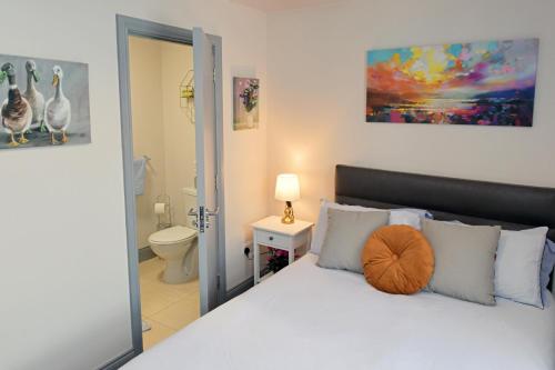 a bedroom with a bed and a bathroom at Pier House Room in Dingle