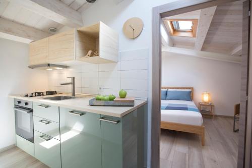 Una cocina con fregadero y una cama en una habitación. en Funduq ospitalità iblea, en Pozzallo