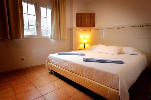 a bedroom with a bed with two towels on it at Aparthotel Maracaibo in Puerto Rico de Gran Canaria