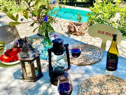 a table with wine glasses and bottles of wine at Villa Eva Agni with private pool by DadoVillas in Agní