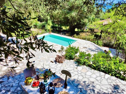 a backyard with a swimming pool and a table with food at Villa Eva Agni with private pool by DadoVillas in Agní