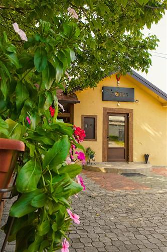 a building with a sign on it with pink flowers at Vila Chess in Belgrade