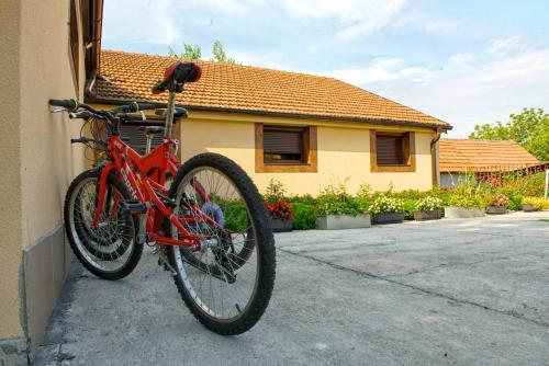 a red bike parked on the side of a house at Vila Chess in Belgrade