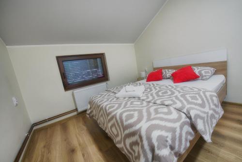 a bedroom with a large bed and a window at Vila Chess in Belgrade