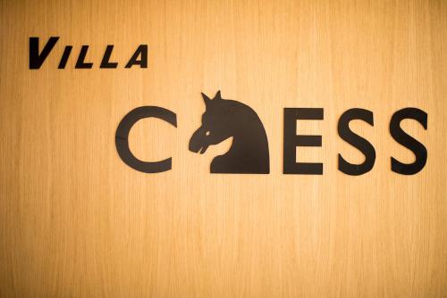 a sign with a black horse on a wall at Vila Chess in Belgrade