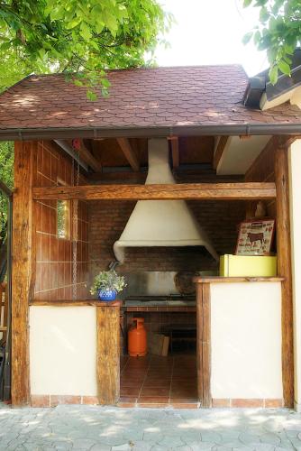 a kitchen in a wooden structure with a roof at Vila Chess in Belgrade