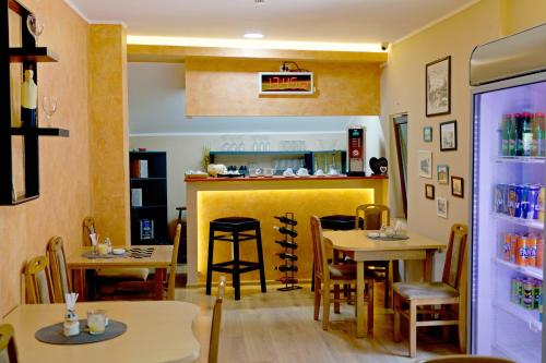 a restaurant with tables and chairs and a counter at Vila Chess in Belgrade