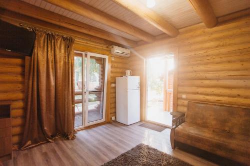 a room with a refrigerator and a window in a cabin at Nika2 Hotel in Zatoka