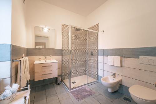 a bathroom with a shower and a toilet and a sink at Casa Mary Family Apartment in Sorrento