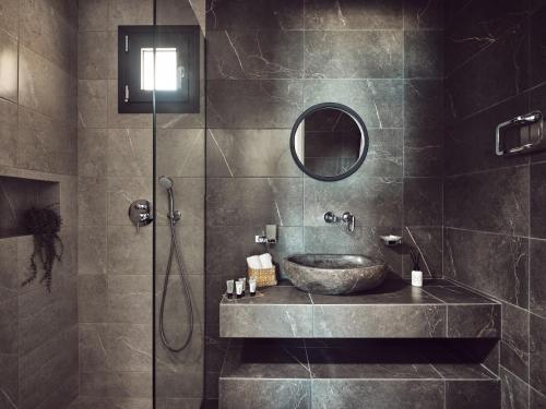 a bathroom with a sink and a shower at LaMer SeaFront Villa, Zante Zen By ThinkVilla in Kipseli