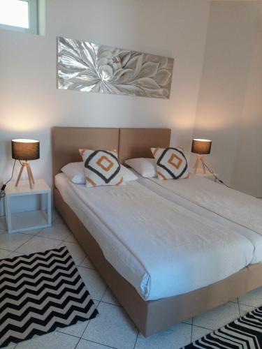 a bedroom with two beds and two lamps in it at Accommodation Zara in Vukovar