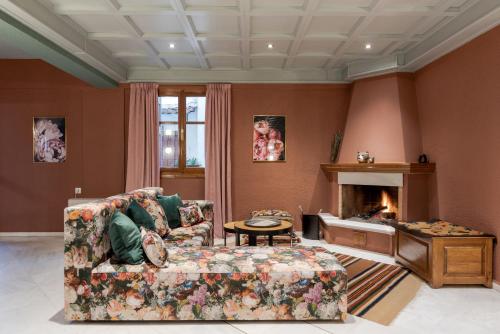 a living room with a couch and a fireplace at Paeonia Arachova in Arachova