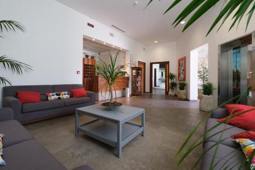 a living room with a couch and a table at Hotel Portavaldera in Peccioli