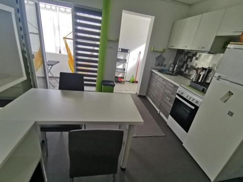 a kitchen with a white table and chairs in it at Laura's dream Appartments in Pag