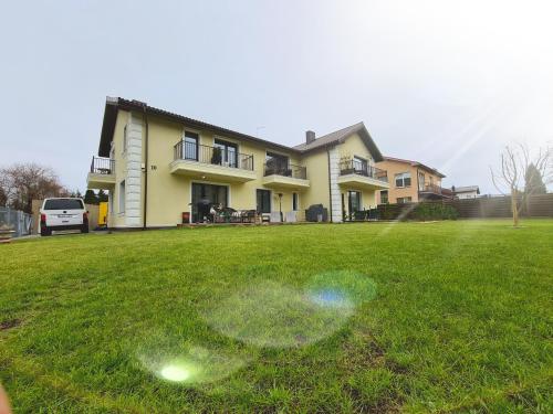 a yard with a bubble in the grass in front of a house at Sakura_INN Palanga in Palanga