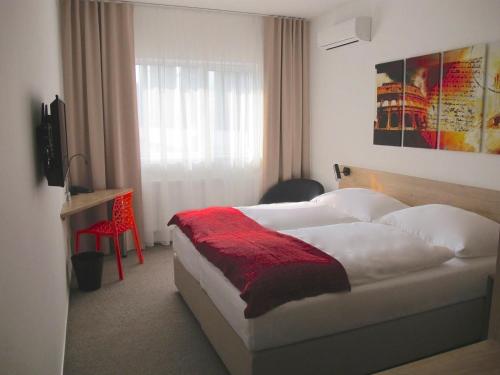 Säng eller sängar i ett rum på Hotel Kapitol