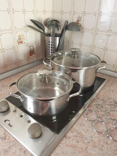 three pots sitting on a stove in a kitchen at oasis RELAX Corralejo in Parque Holandes