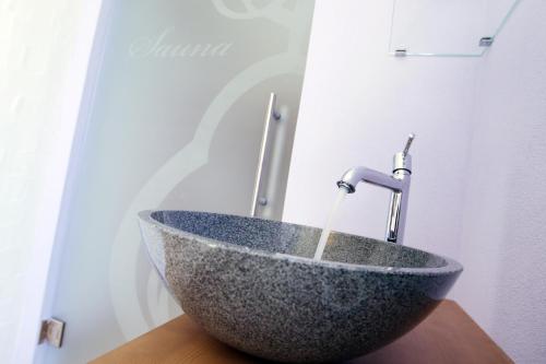 a stone bowl sink with a faucet on a table at Perbersdorfer Heuriger in Neuhofen an der Ybbs