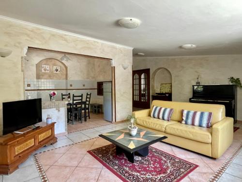 a living room with a couch and a table at Home Sweet Home in Gallicano nel Lazio