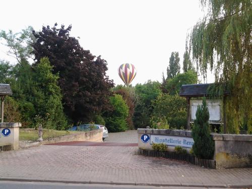 a hot air balloon flying in the sky over a street at La Renaudière in Chenonceaux