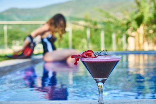 a drink sitting next to a swimming pool at Chateau de Georges in Gythio