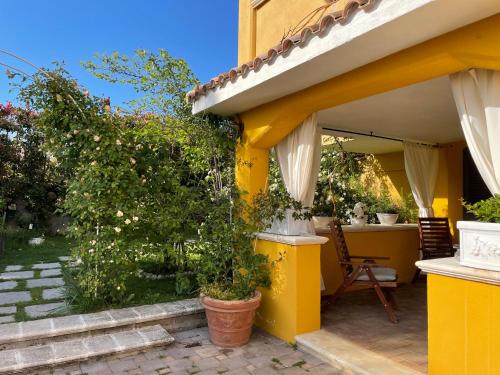 a yellow house with a table and chairs on a patio at Home Sweet Home in Gallicano nel Lazio