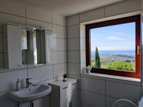 a bathroom with a sink and a window at Bellevue in Marezige