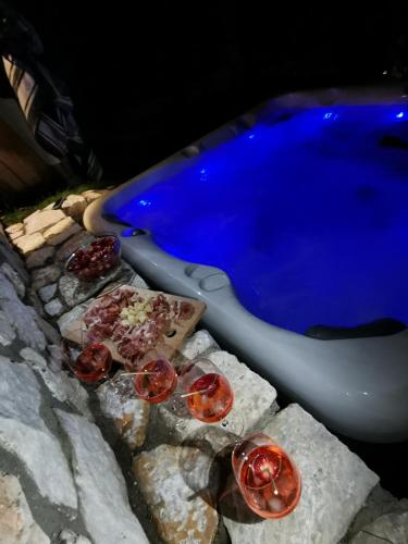 a group of tomatoes on rocks next to a swimming pool at Sindy Wooden Apartments in Mavrovo