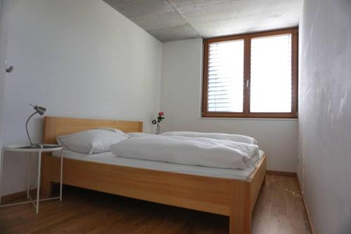 a bedroom with a large bed with a window at Terrassenwohnung in prämierter Wohnanlage in Klaus