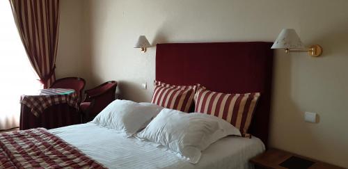a hotel room with a bed with white pillows at Hotel Argi Eder in Aïnhoa