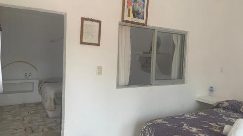 a bedroom with a mirror and a bed and a sink at Hotel Puerto Villamar in Tepoztlán