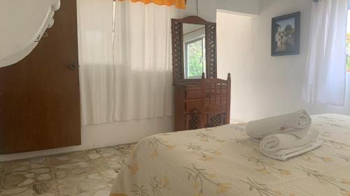 a bedroom with a bed with a laptop on it at Hotel Puerto Villamar in Tepoztlán