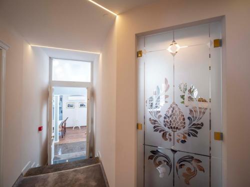 a hallway with a door with a flower pattern on it at The Moon Boutique Hotel in Sofia