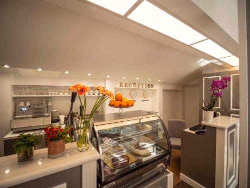 a kitchen with a display case with flowers in it at The Moon Boutique Hotel in Sofia