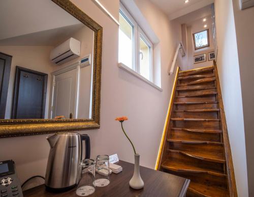 a room with a table with a mirror and a staircase at The Moon Boutique Hotel in Sofia