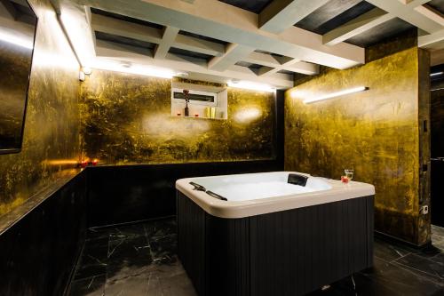 a bathroom with a tub and a sink at Apartments in Kaunas city centre with Jacuzzi bath in Kaunas