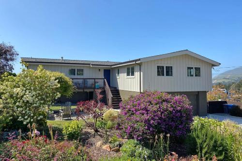 a house with flowers in front of it at Ocean & Mountain View Home - Walk to Trails Beach Family Activities in Montara