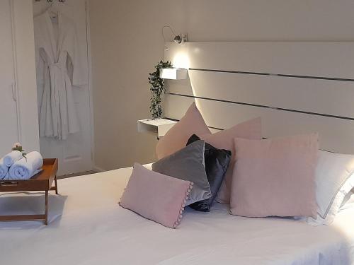 a bedroom with a bed with pillows on it at Sunny-side-up in St Austell
