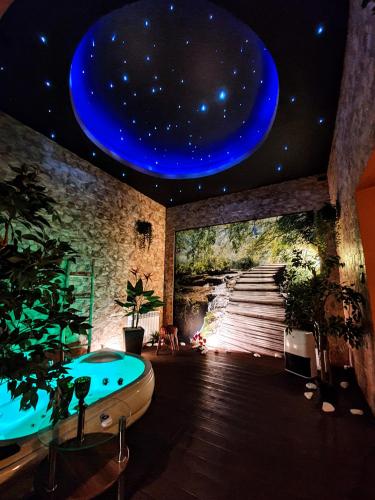 a room with a bath tub and a painting of a universe at Apartament z jacuzzi Kraków in Krakow
