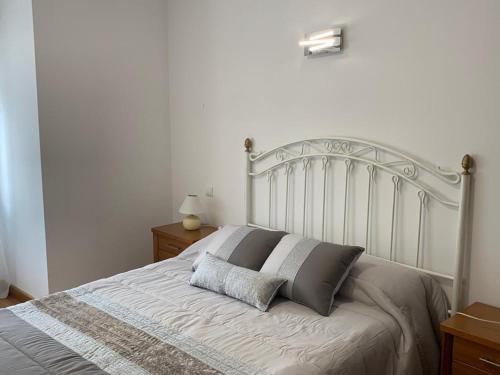 a bed with two pillows on it in a bedroom at Apartamento Bella Vista in Suances