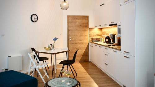 a kitchen and dining room with a table and chairs at BeTree in Bratislava