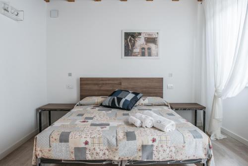 Ένα ή περισσότερα κρεβάτια σε δωμάτιο στο Carrera Home Appartamenti Verona - Bike Hotel