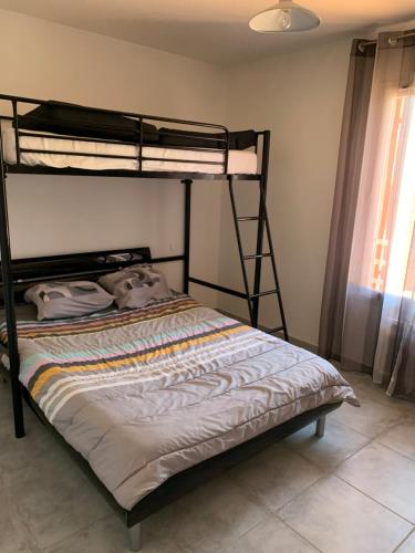 a bedroom with two bunk beds in a room at Propriété Rebardo in Hyères