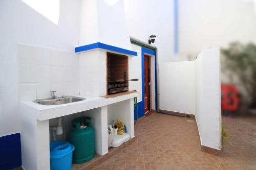 a small bathroom with a sink and a counter at Casa Alentejana in Vila Nova de Milfontes
